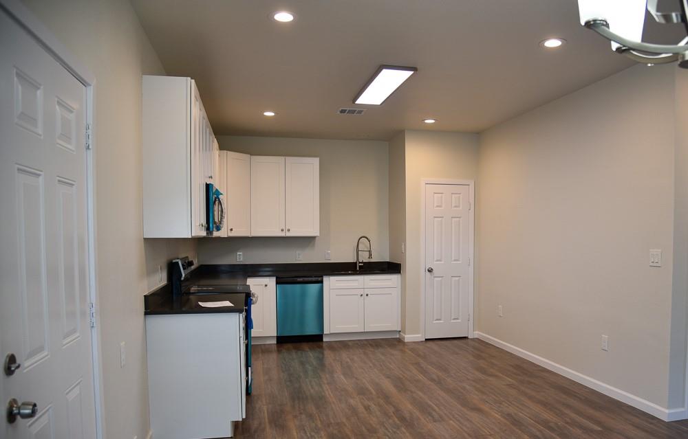 1602 North Mcdonald Avenue Decatur, TX 76234 - Photo 9 of 13 a kitchen with granite countertop a stove and a refrigerator