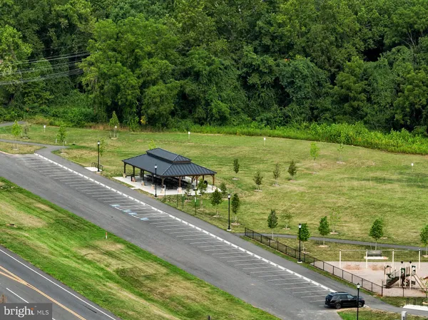 an aerial view of residential houses with outdoor space and trees