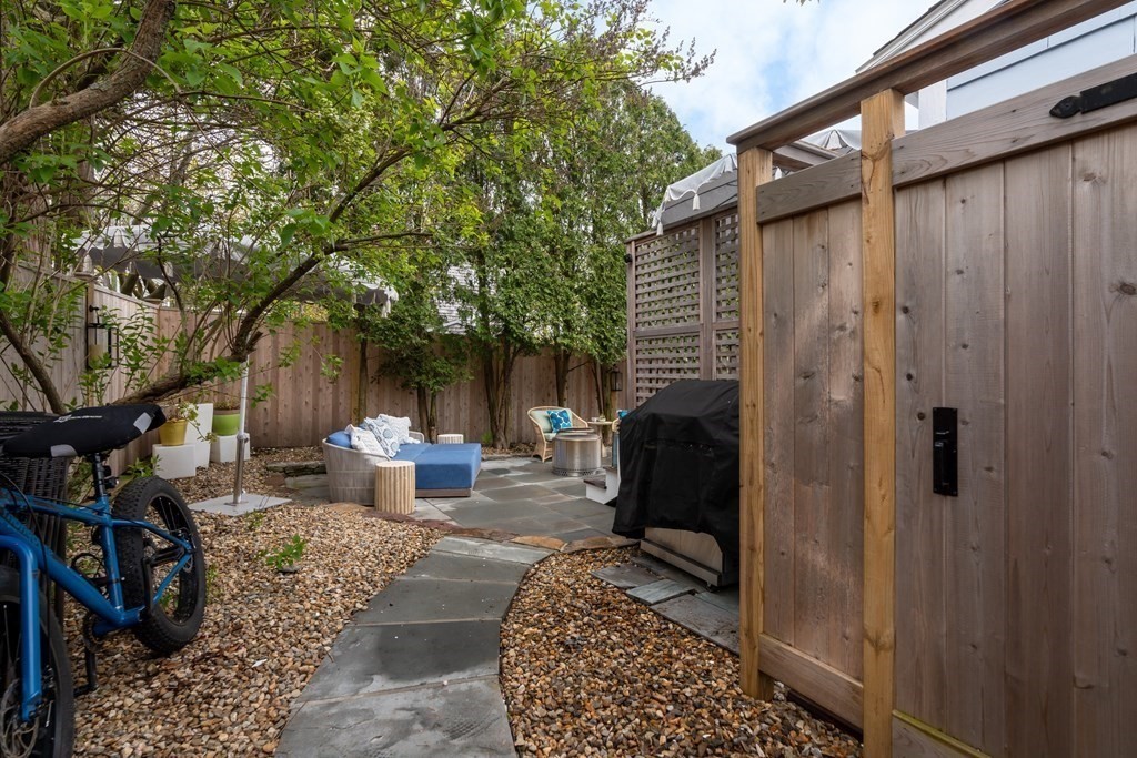 94 Pitman Road Marblehead, MA 01945 - Photo 13 of 35 a view of a patio with table and chairs and potted plants