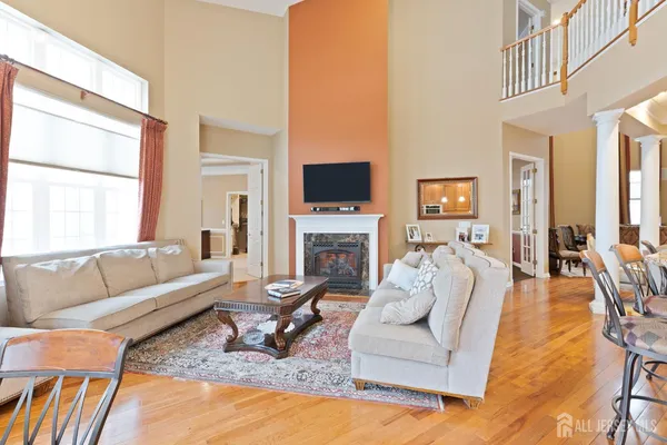 a living room with fireplace furniture and a flat screen tv