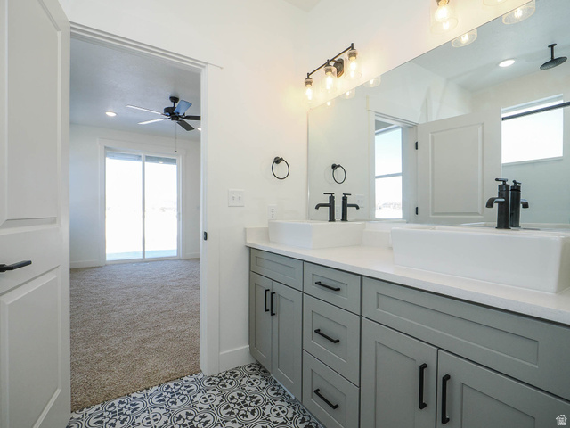 3938 North Wood Road Eagle Mountain, UT 84005 - Photo 22 of 55 Full bathroom featuring double vanity, healthy amount of natural light, light colored carpet, recessed lighting, and light tile patterned flooring