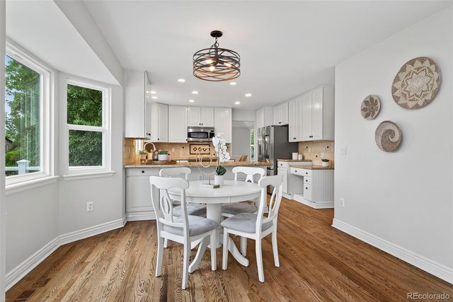 a view of a dining room with furniture window and wooden floor