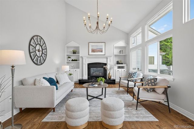 a living room with furniture a fireplace and a large mirror