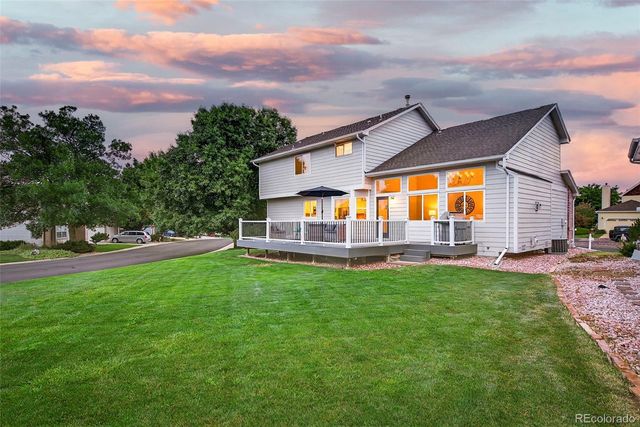 a view of a house with backyard porch and sitting area