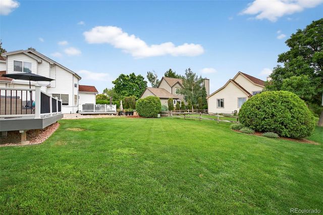 a view of a house with a big yard and potted plants