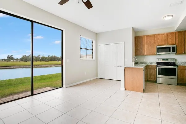 a kitchen with stainless steel appliances granite countertop a stove a sink and a microwave