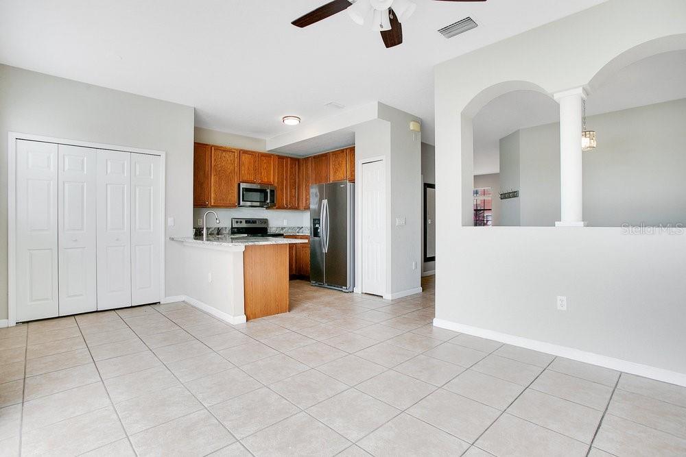 3466 Allegra Circle St. Cloud, FL 34772 - Photo 10 of 29 a kitchen with granite countertop a stove a sink and a refrigerator
