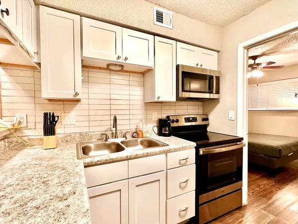 a kitchen with a sink stove and microwave