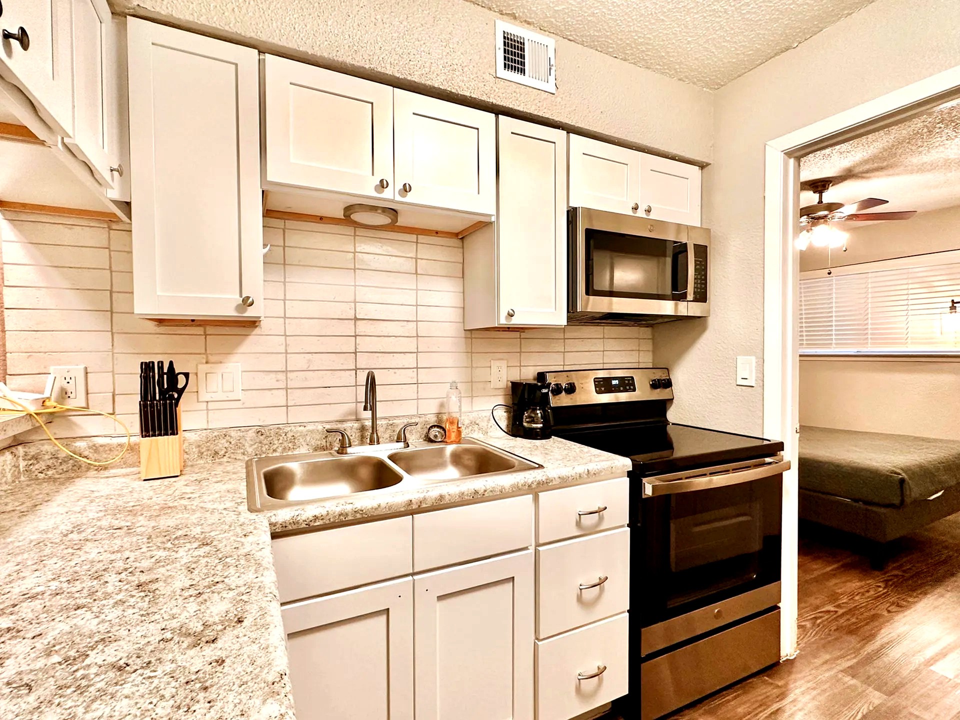 2808 Whitis Avenue, Unit C207 Austin, TX 78705 - Photo 2 of 5 a kitchen with a sink stove and microwave