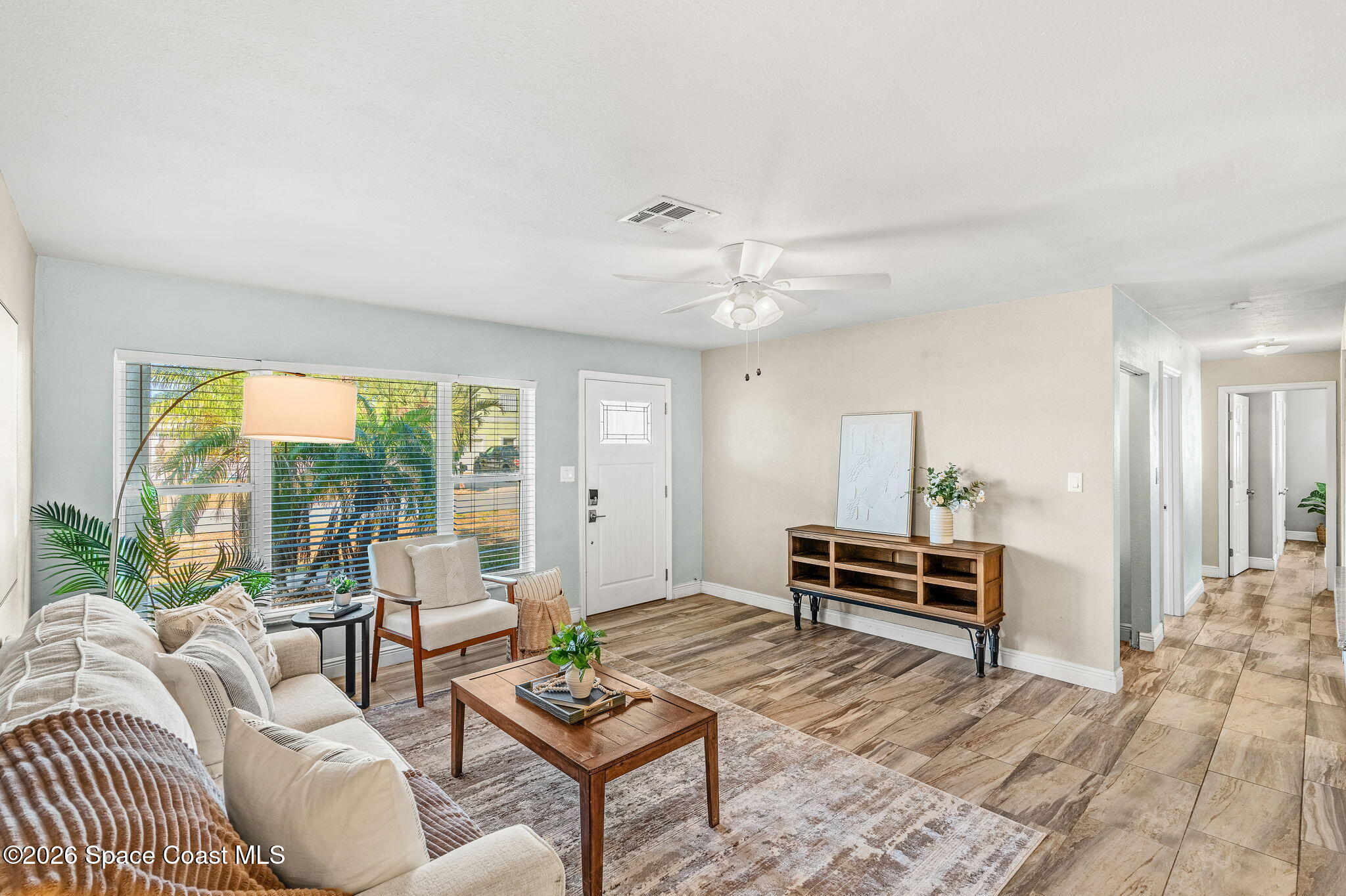 340 West Exeter Street Satellite Beach, FL 32937 - Photo 11 of 39 a living room with furniture a large window and a table