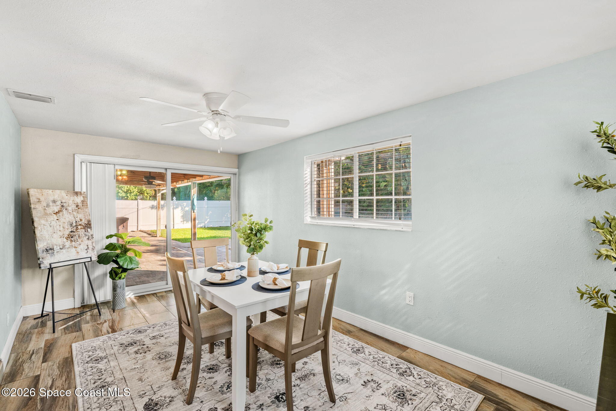 340 West Exeter Street Satellite Beach, FL 32937 - Photo 17 of 39 a view of a dining room with furniture and a window
