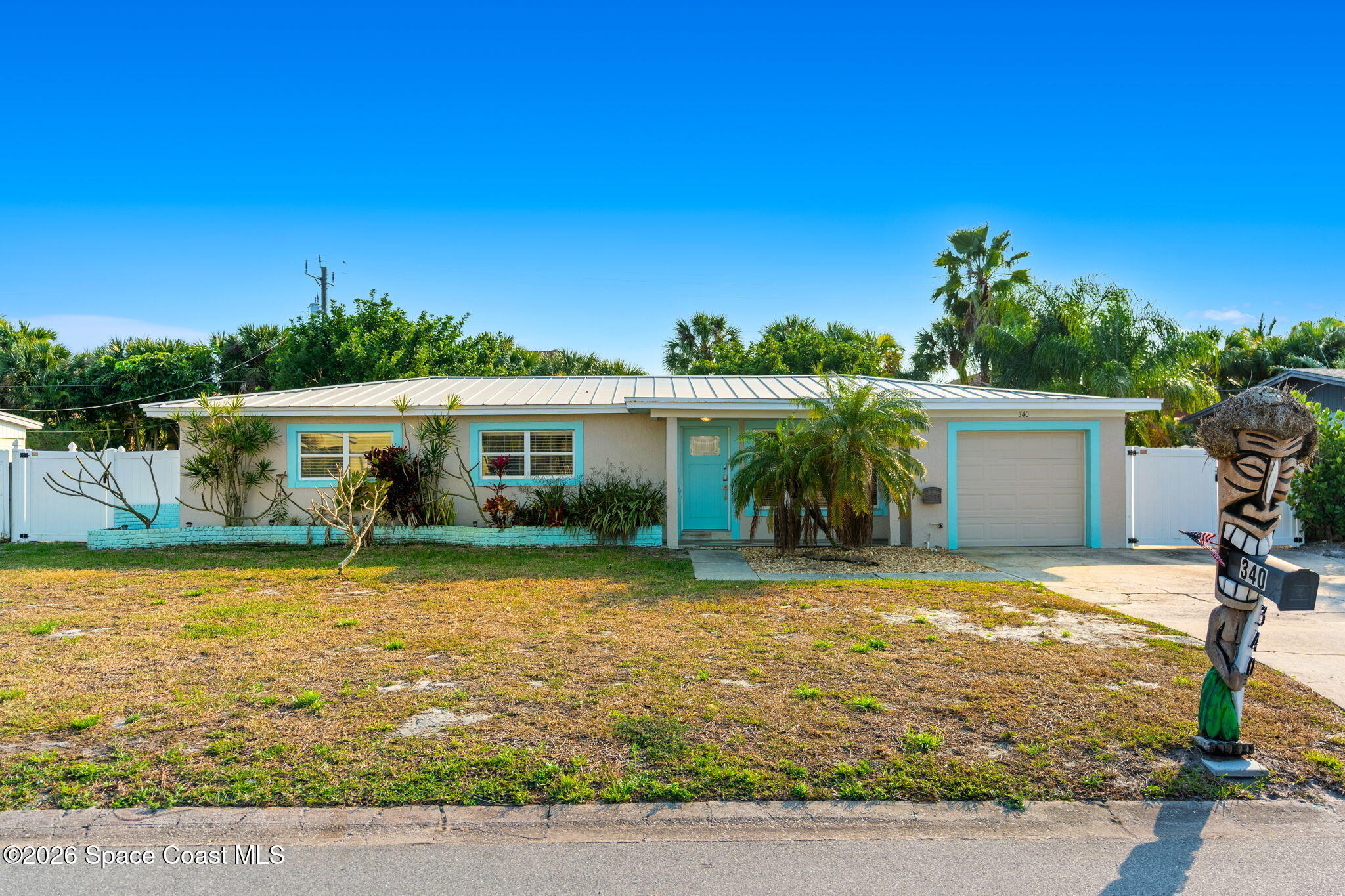 340 West Exeter Street Satellite Beach, FL 32937 - Photo 2 of 39 a front view of house with yard and seating