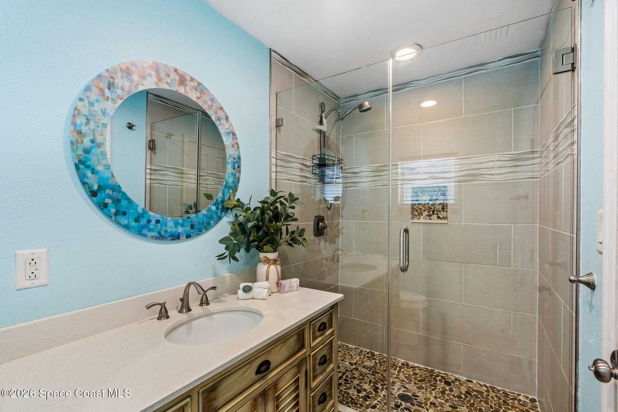 340 West Exeter Street Satellite Beach, FL 32937 - Photo 21 of 39 a bathroom with a sink shower and a mirror