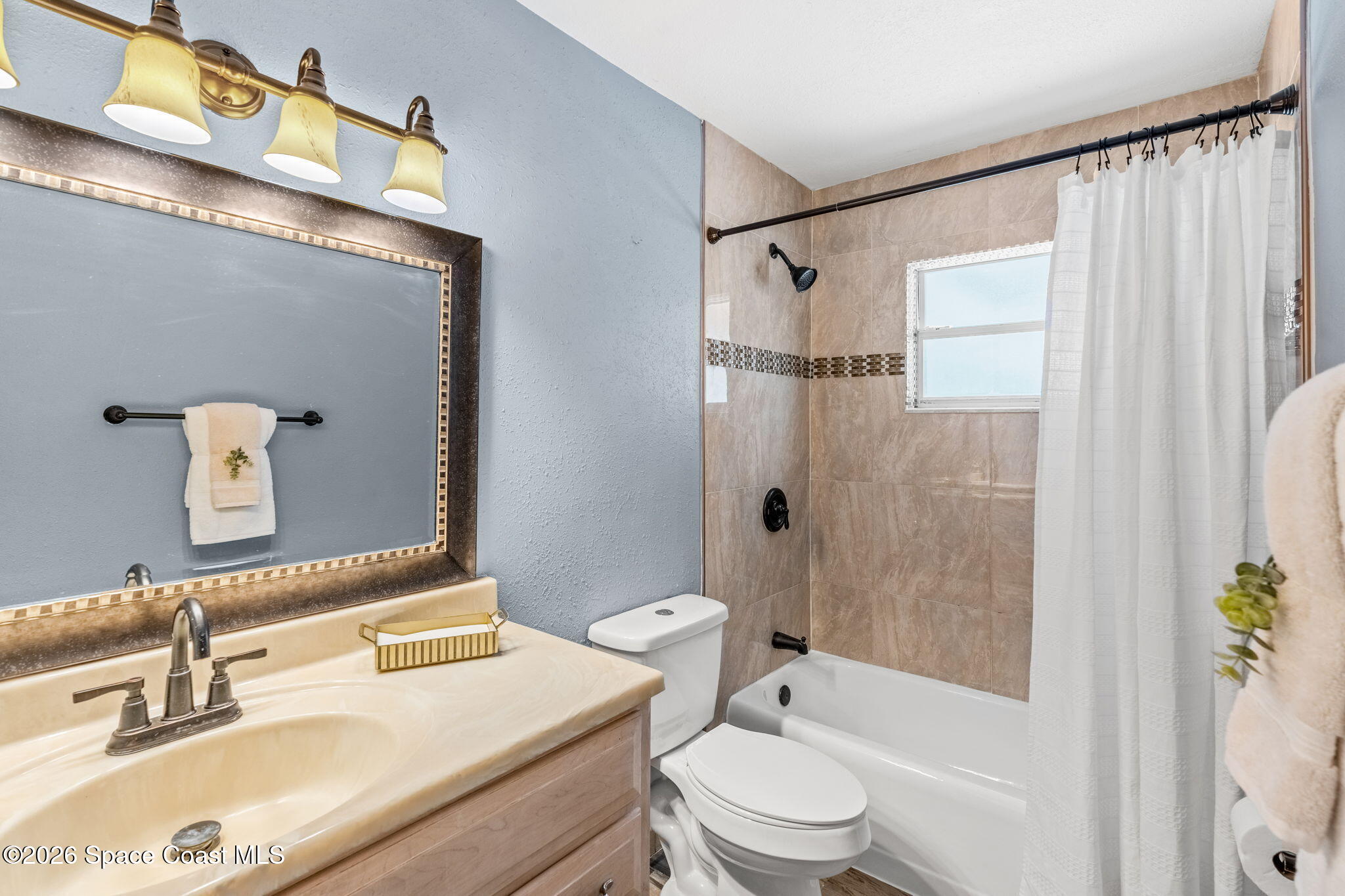 340 West Exeter Street Satellite Beach, FL 32937 - Photo 23 of 39 a bathroom with a sink a toilet and shower