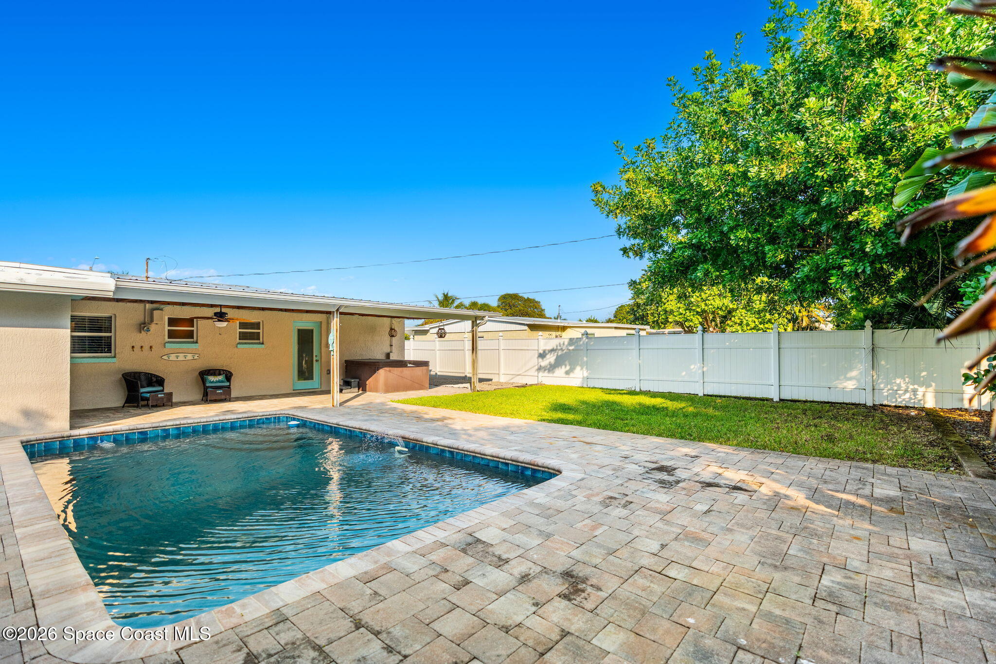 340 West Exeter Street Satellite Beach, FL 32937 - Photo 34 of 39 a view of a swimming pool with an outdoor space and seating area