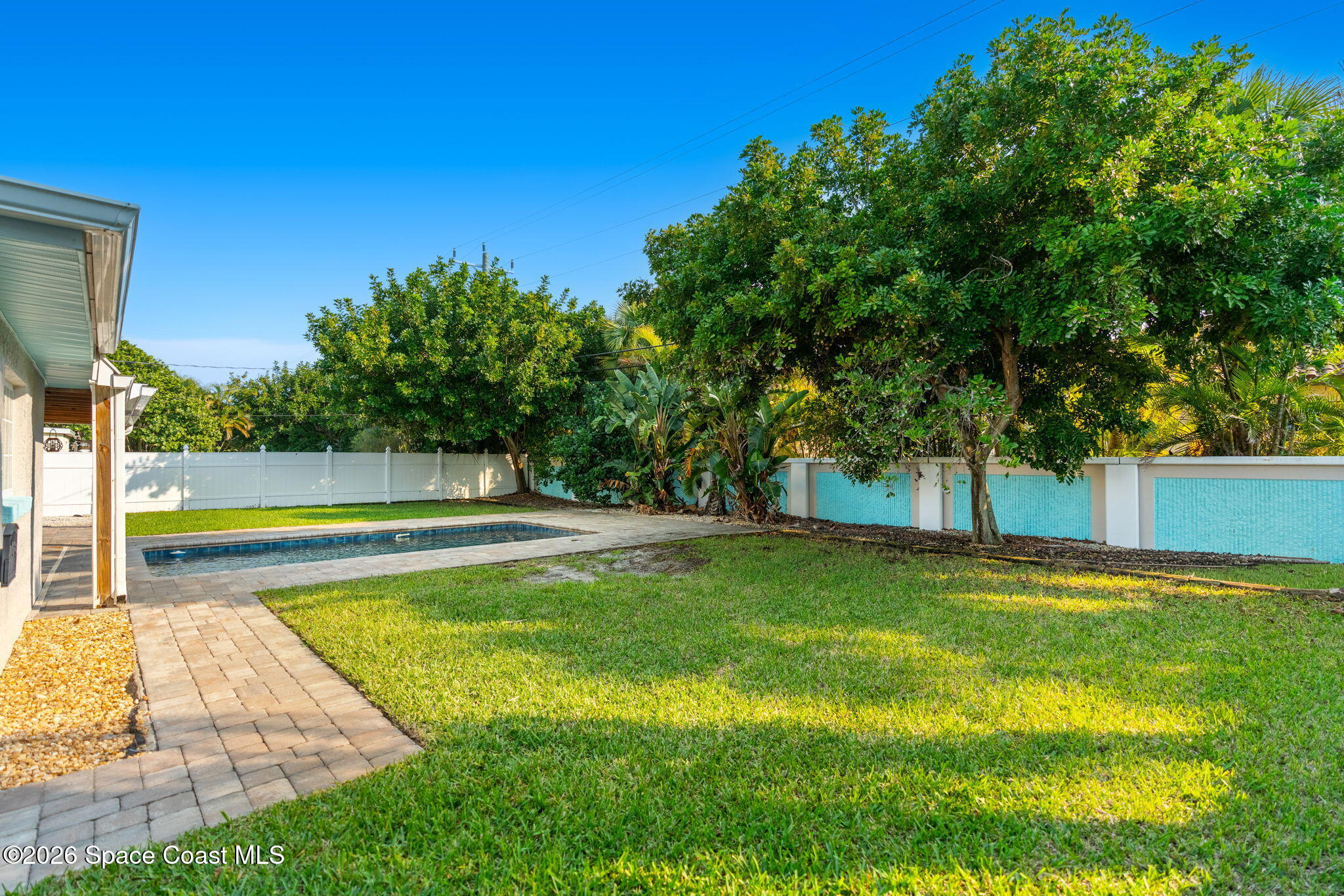 340 West Exeter Street Satellite Beach, FL 32937 - Photo 35 of 39 a view of backyard with swimming pool and seating space