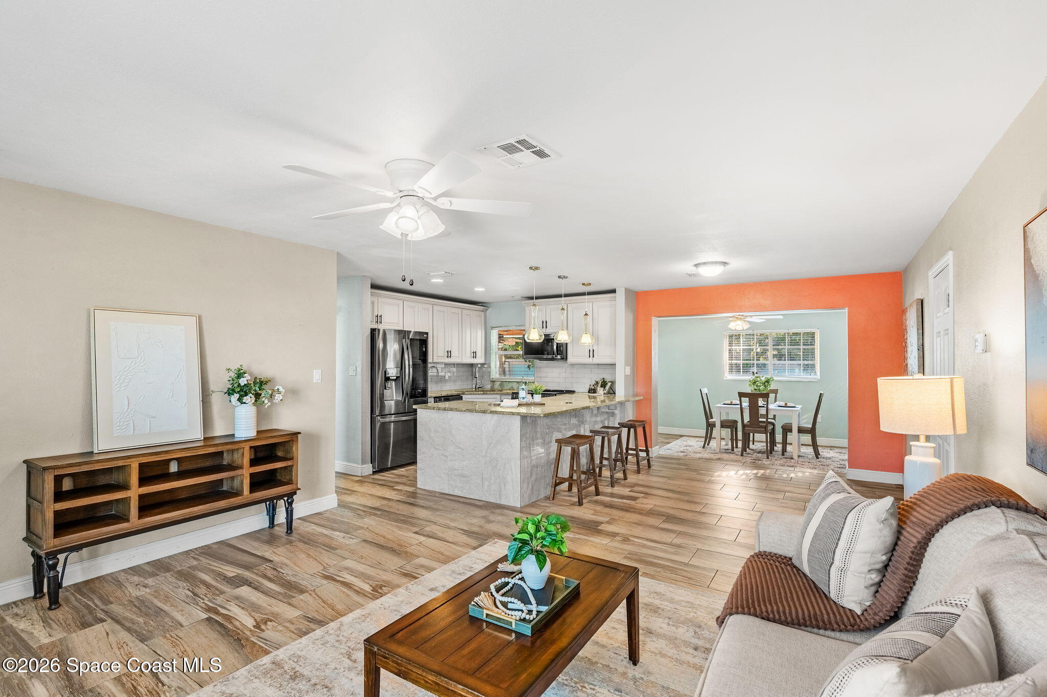 340 West Exeter Street Satellite Beach, FL 32937 - Photo 10 of 39 a living room with furniture and wooden floor