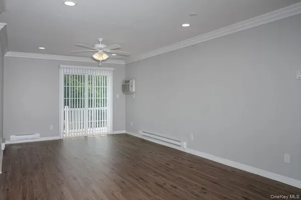 a view of wooden floor and windows in a room