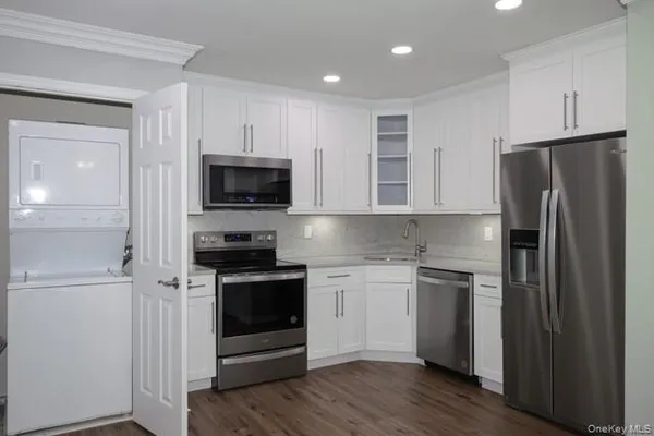 a kitchen with a refrigerator stove and microwave