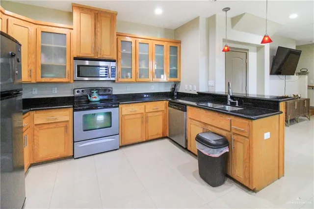 a kitchen with stainless steel appliances granite countertop a sink stove and microwave