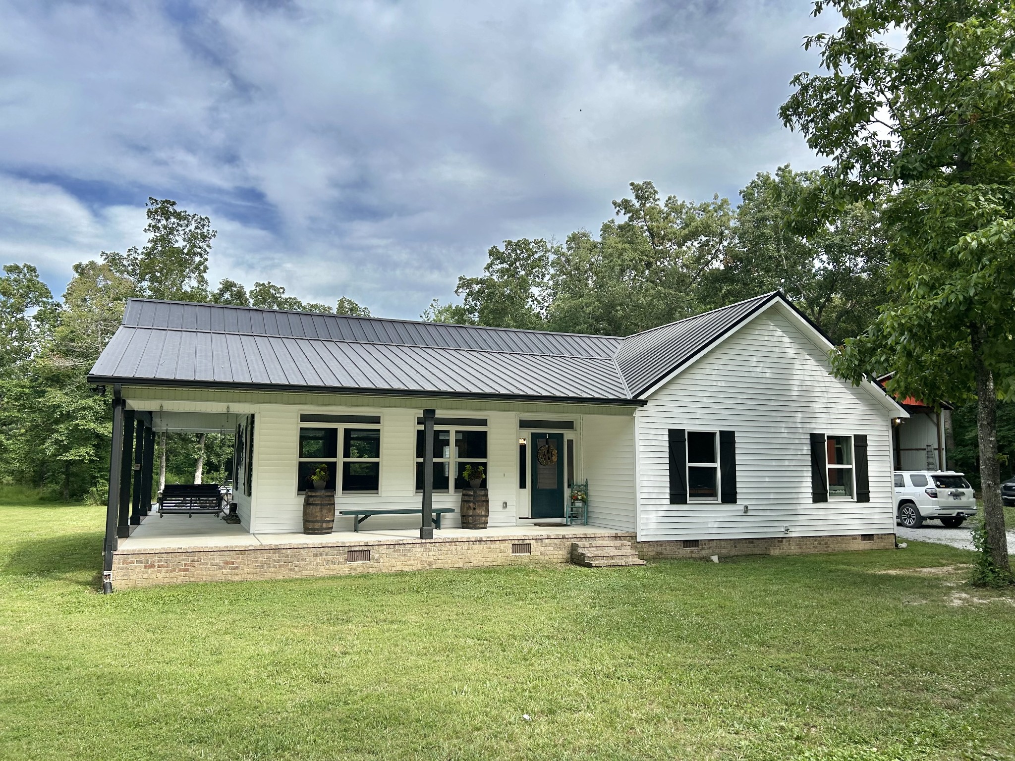 795 Cat Creek Road Manchester, TN 37355 - Photo 1 of 58 a view of a white house with a big yard and potted plants