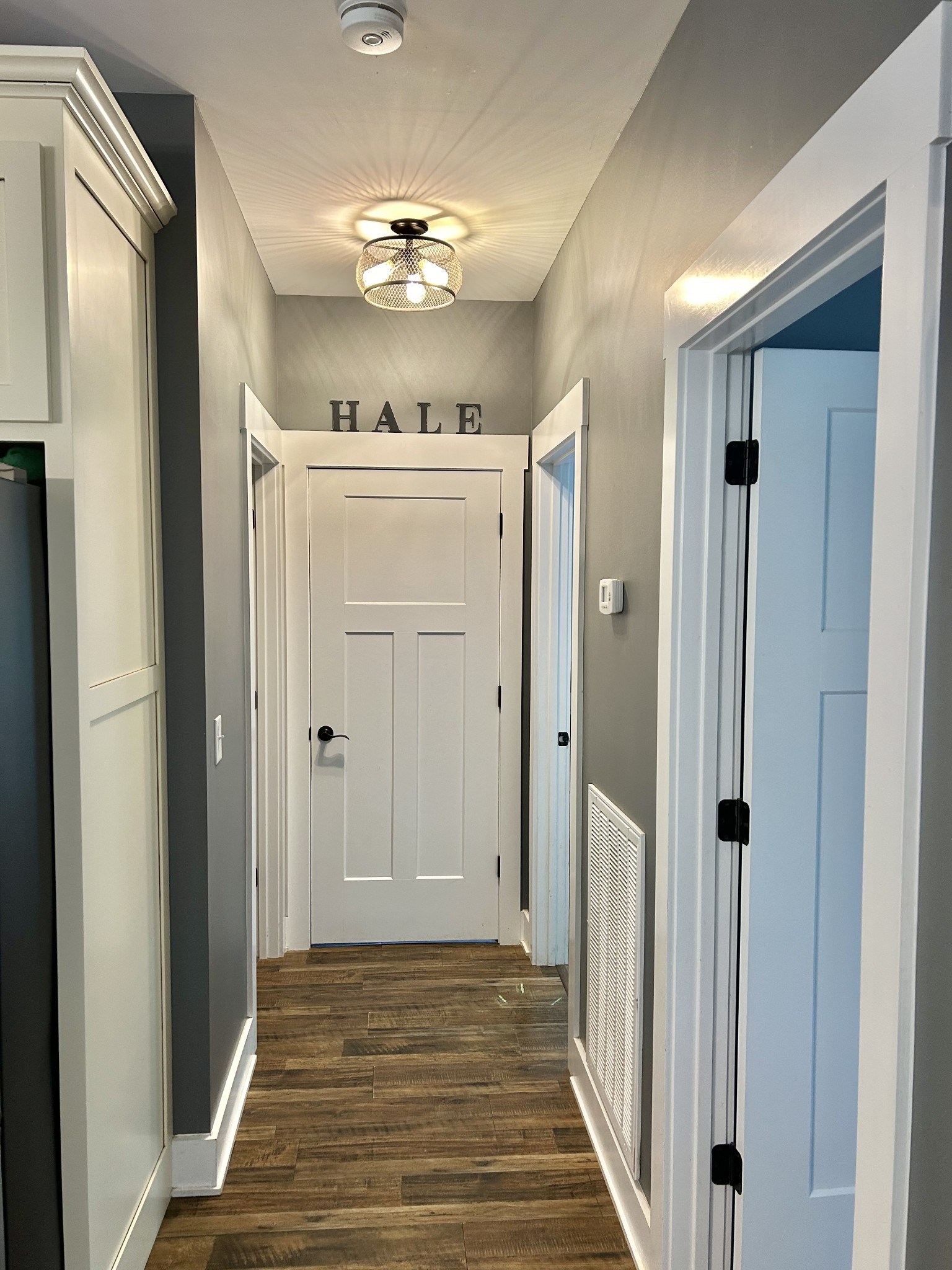 795 Cat Creek Road Manchester, TN 37355 - Photo 38 of 58 a view of a hallway with wooden floor and chandelier