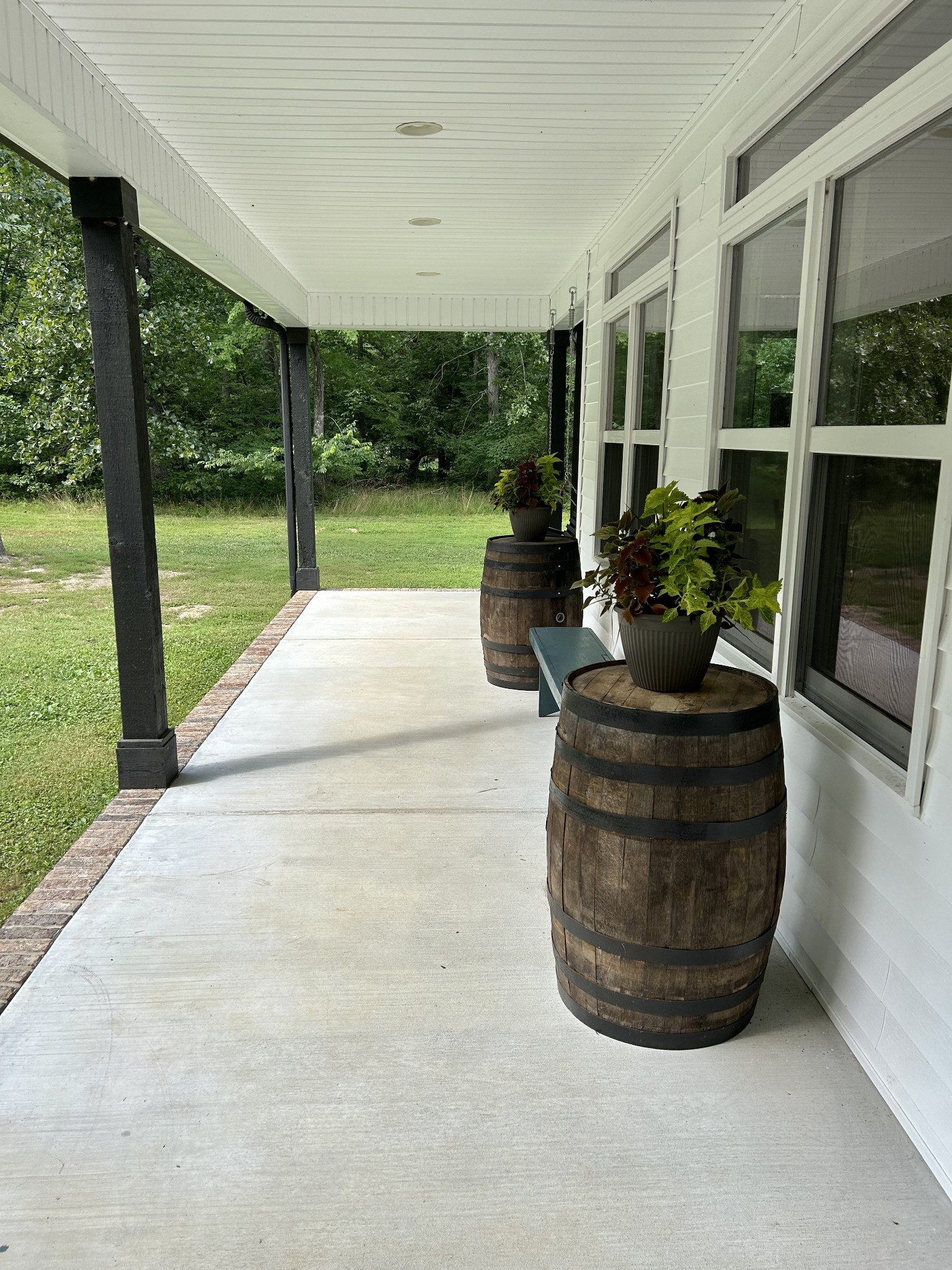 795 Cat Creek Road Manchester, TN 37355 - Photo 7 of 58 a view of a porch with couches potted plants and floor to ceiling window
