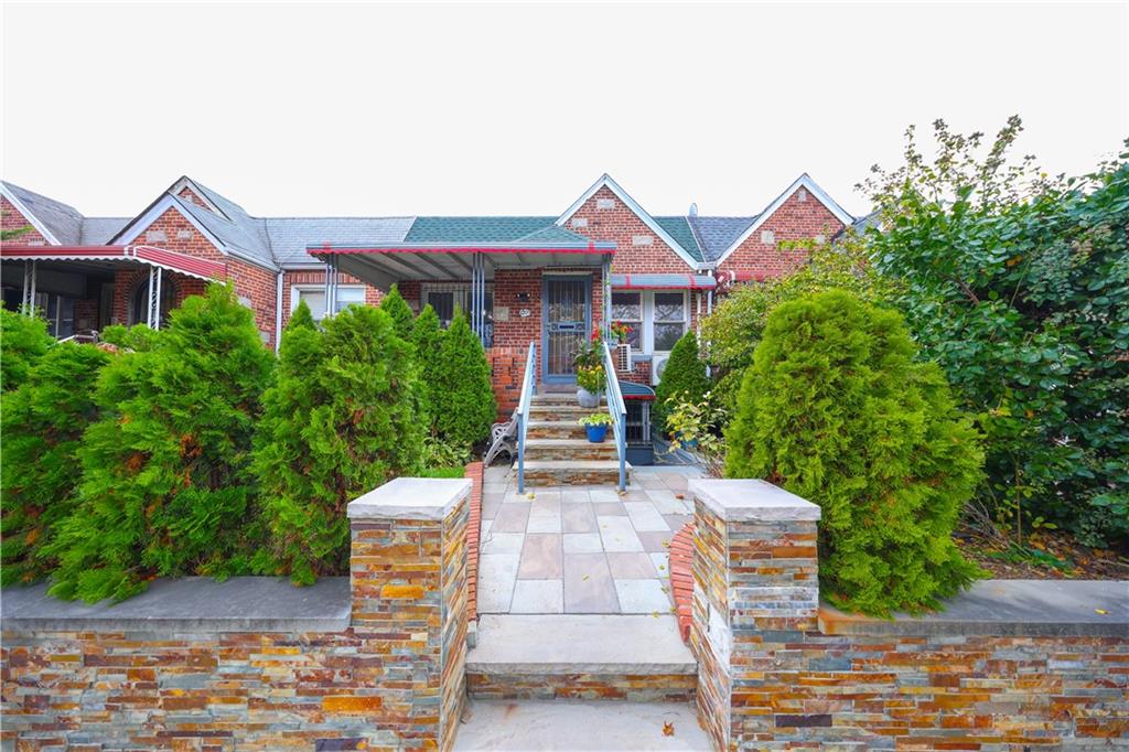 1200 East 49th Street Brooklyn, NY 11234 - Photo 1 of 30 a view of a brick house with many windows plants and large trees