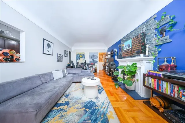 a living room with furniture and a potted plant