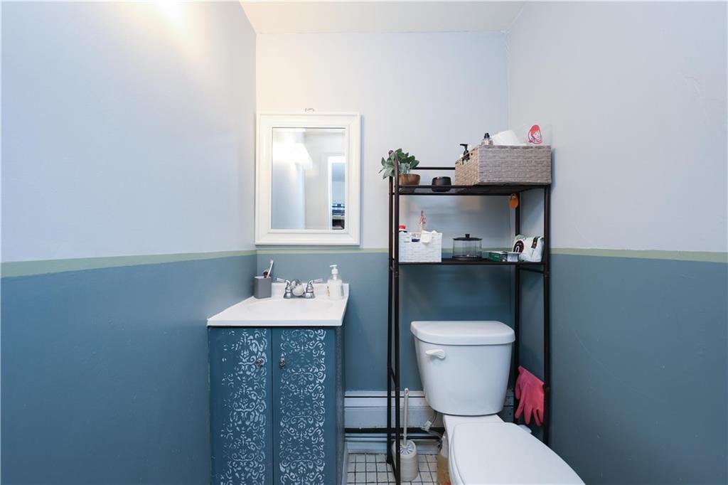 1200 East 49th Street Brooklyn, NY 11234 - Photo 20 of 30 a bathroom with a sink a toilet and a mirror