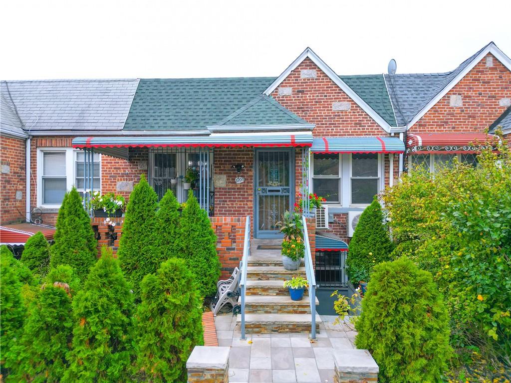 1200 East 49th Street Brooklyn, NY 11234 - Photo 3 of 30 a front view of a house with plants and entryway