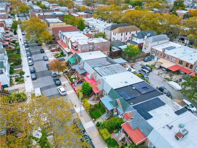 an aerial view of multiple houses with a yard