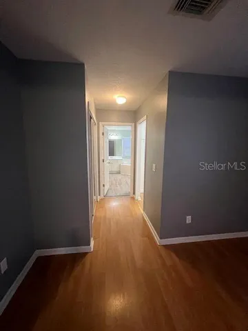 a view of hallway with wooden floor