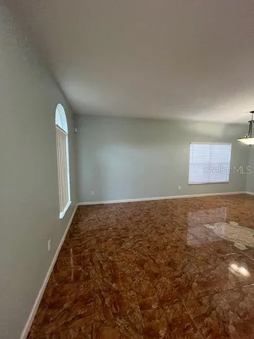 an empty room with a empty space and windows