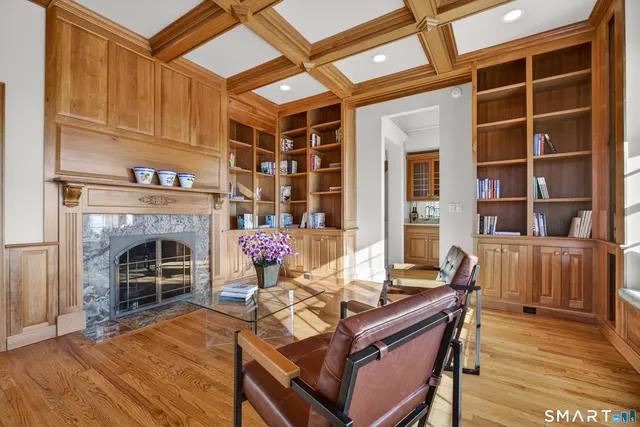 a living room with furniture a fireplace and a wooden floor