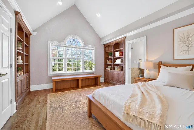 a bedroom with a large bed and a large window