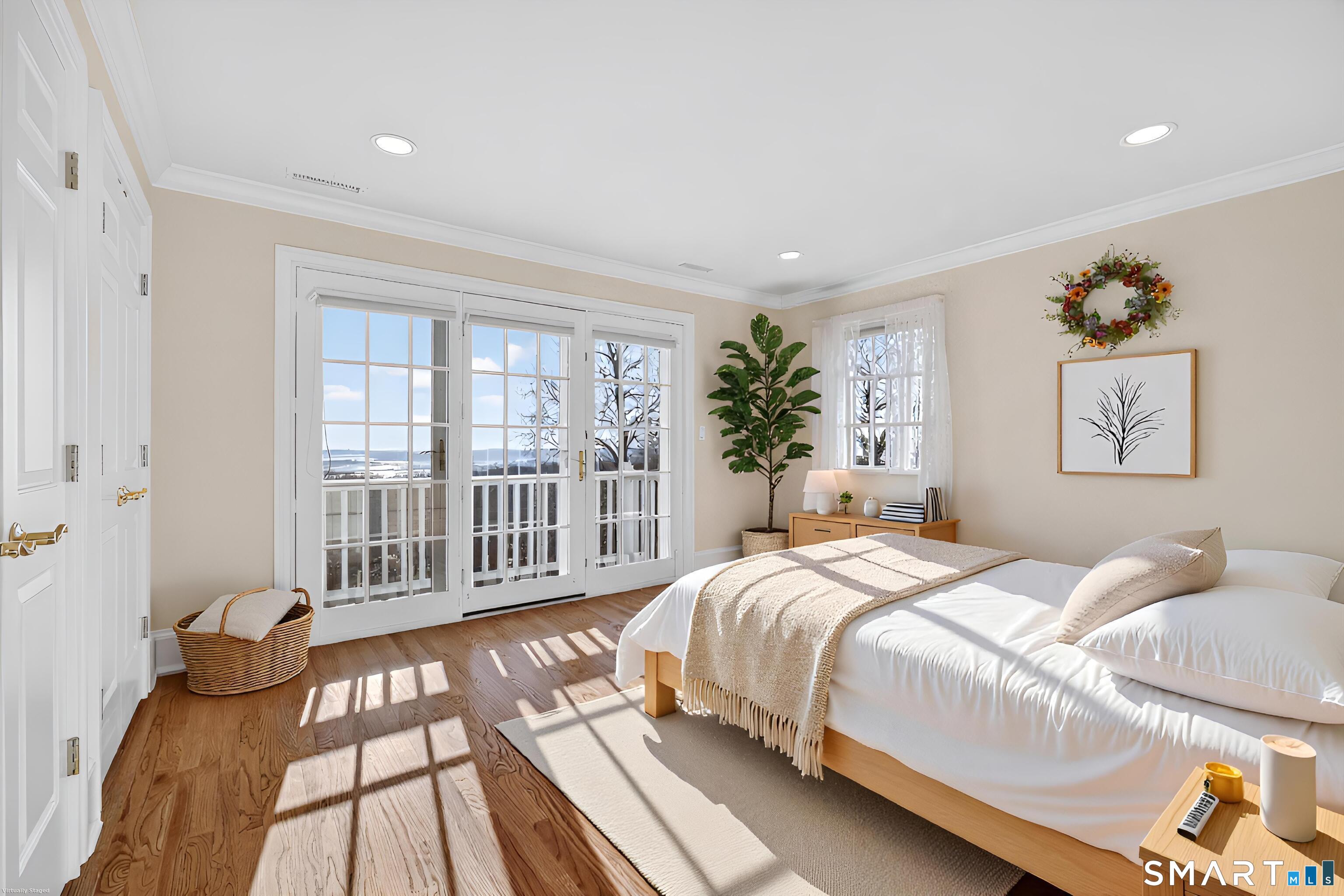 134 River Road Essex, CT 06426 - Photo 30 of 39 a bedroom with a bed and wooden floor