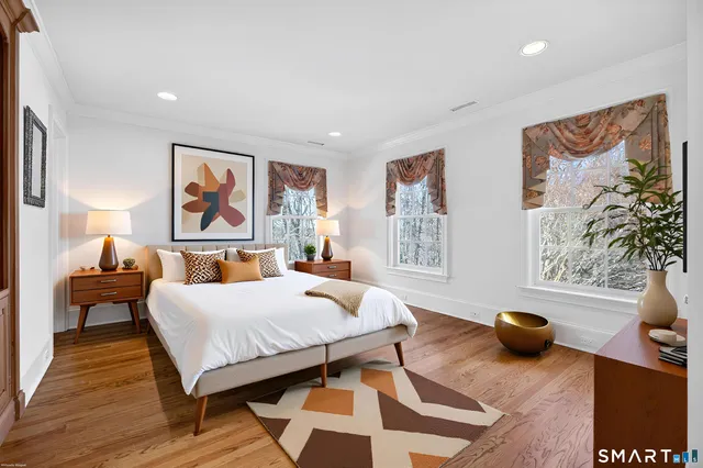 a bedroom with furniture and a wooden floor