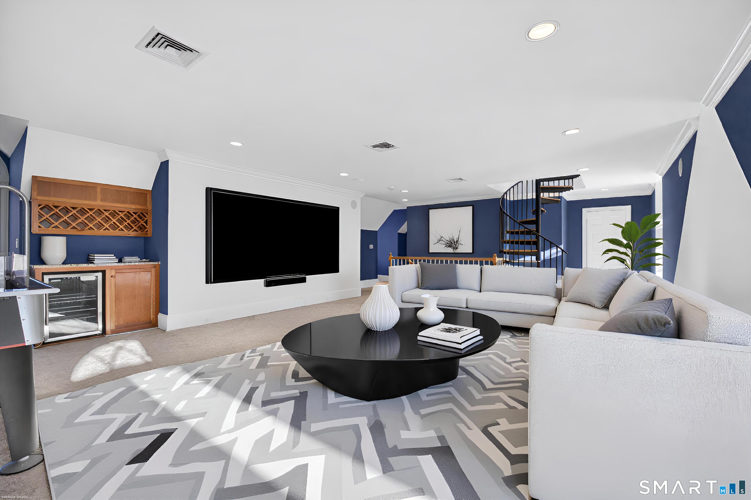 134 River Road Essex, CT 06426 - Photo 33 of 39 a living room with furniture and a flat screen tv