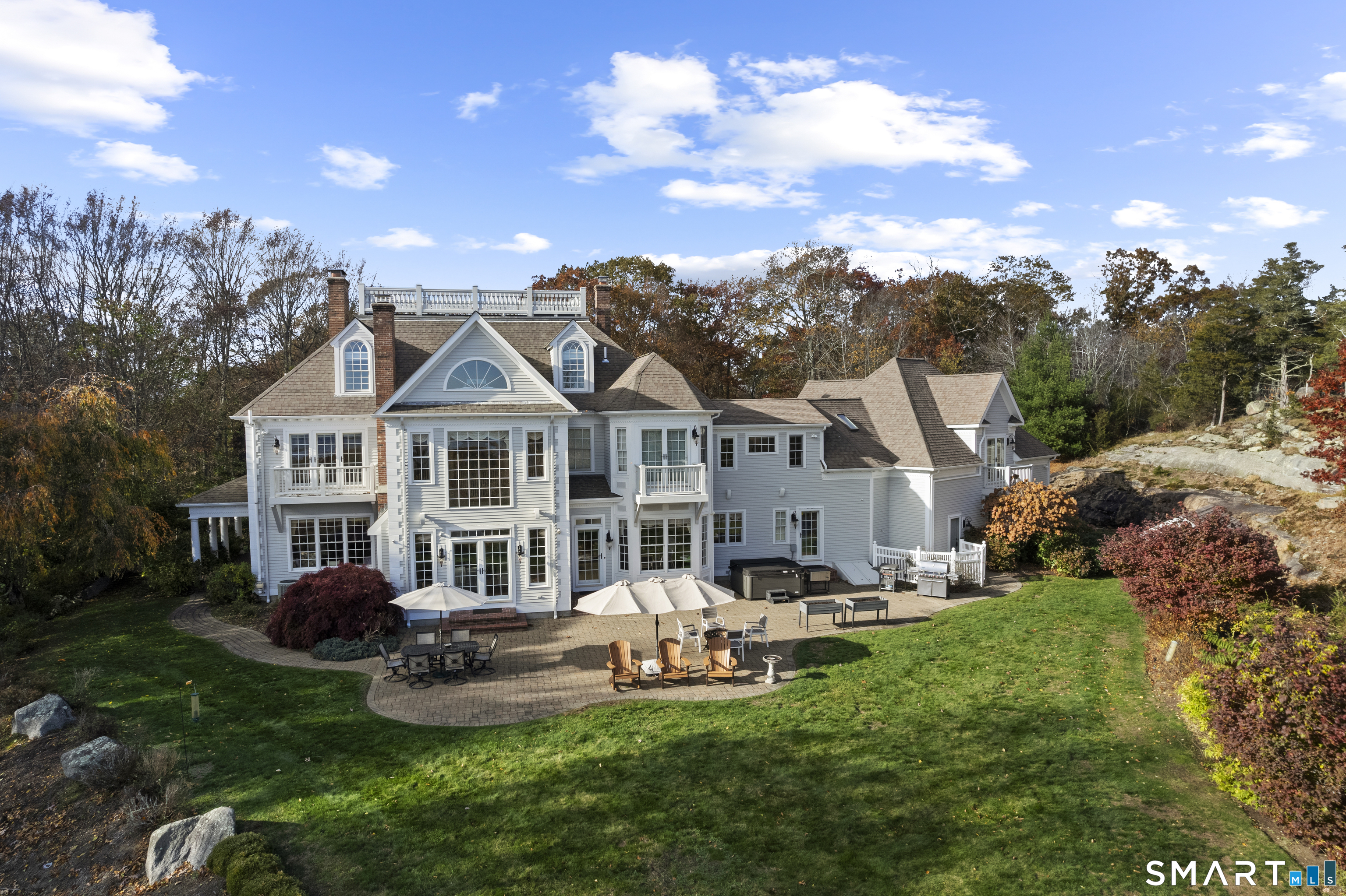 134 River Road Essex, CT 06426 - Photo 4 of 39 a front view of a house with a garden and trees