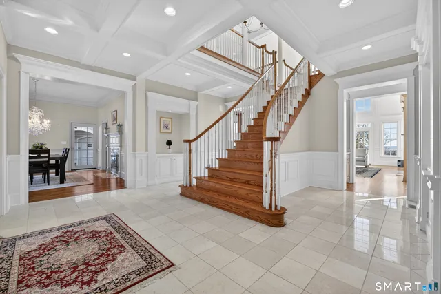 a view of a hallway with dining room and stairs