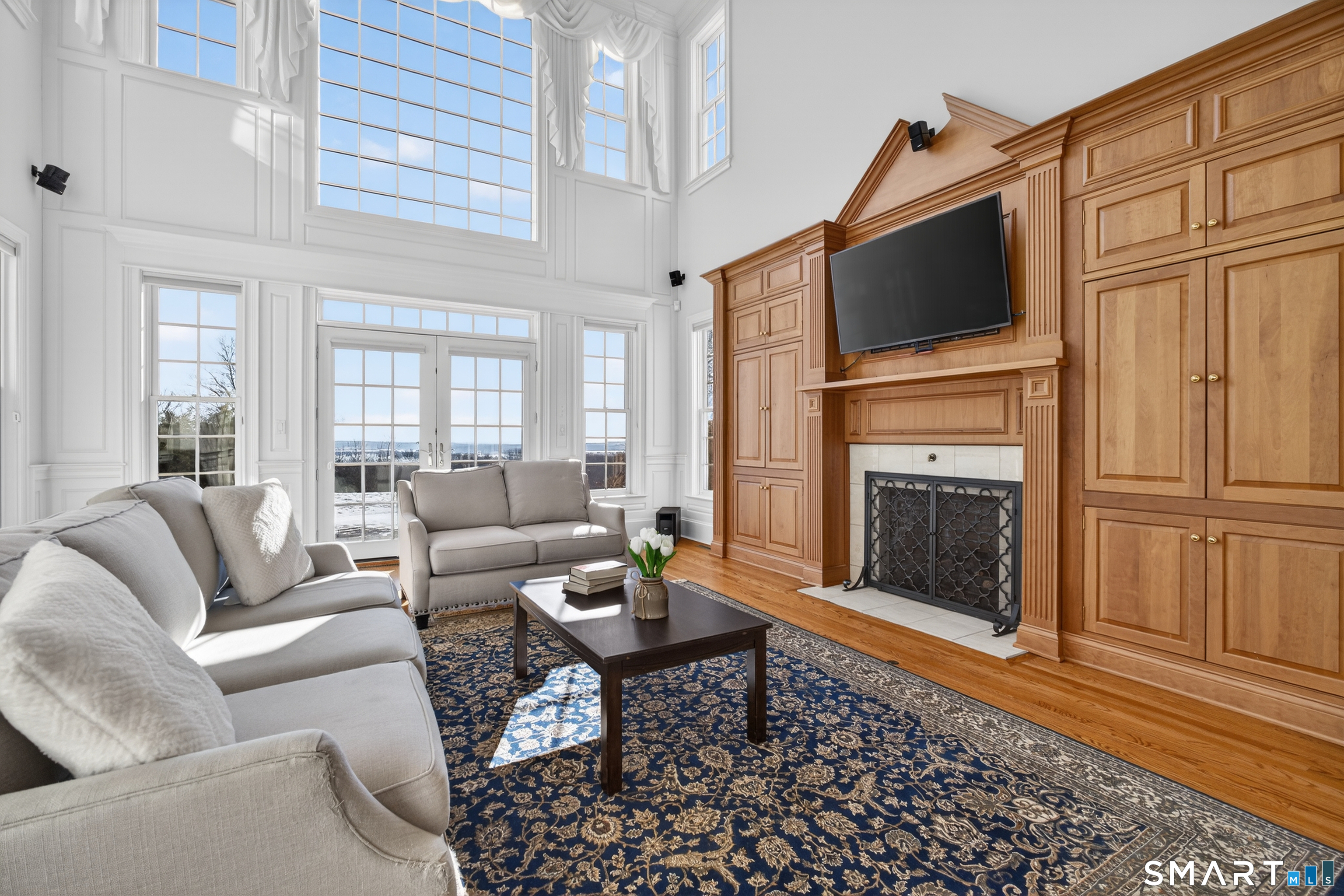 134 River Road Essex, CT 06426 - Photo 7 of 39 a living room with furniture a fireplace and a flat screen tv