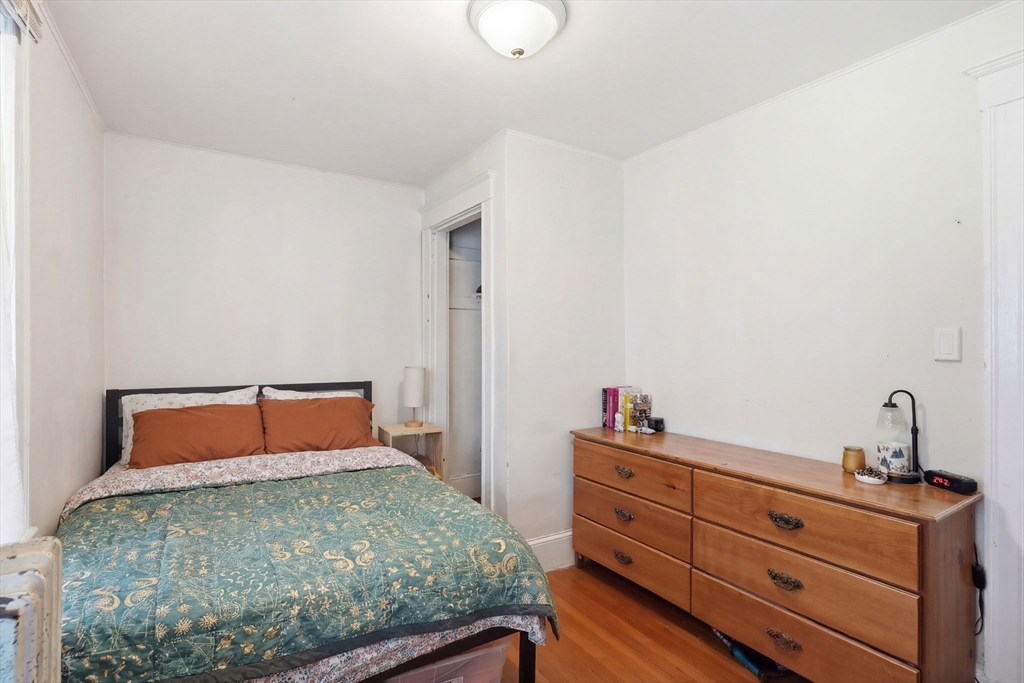 14 Stockwell Street, Unit 2 Boston, MA 02120 - Photo 12 of 29 a bedroom with a bed and a dresser