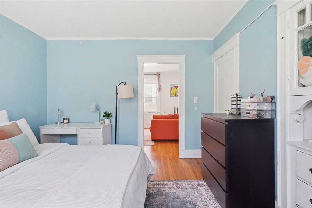 14 Stockwell Street, Unit 2 Boston, MA 02120 - Photo 17 of 29 a room with a bed and wooden floor