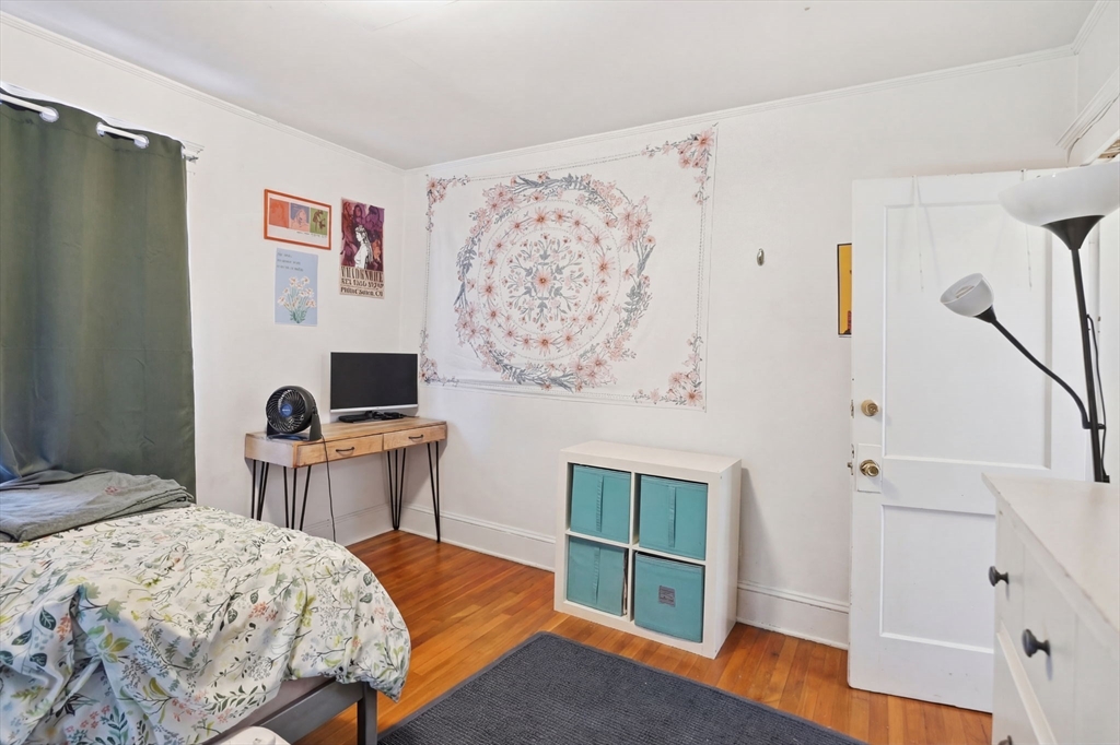 14 Stockwell Street, Unit 2 Boston, MA 02120 - Photo 22 of 29 a bedroom with a bed and a chair in it