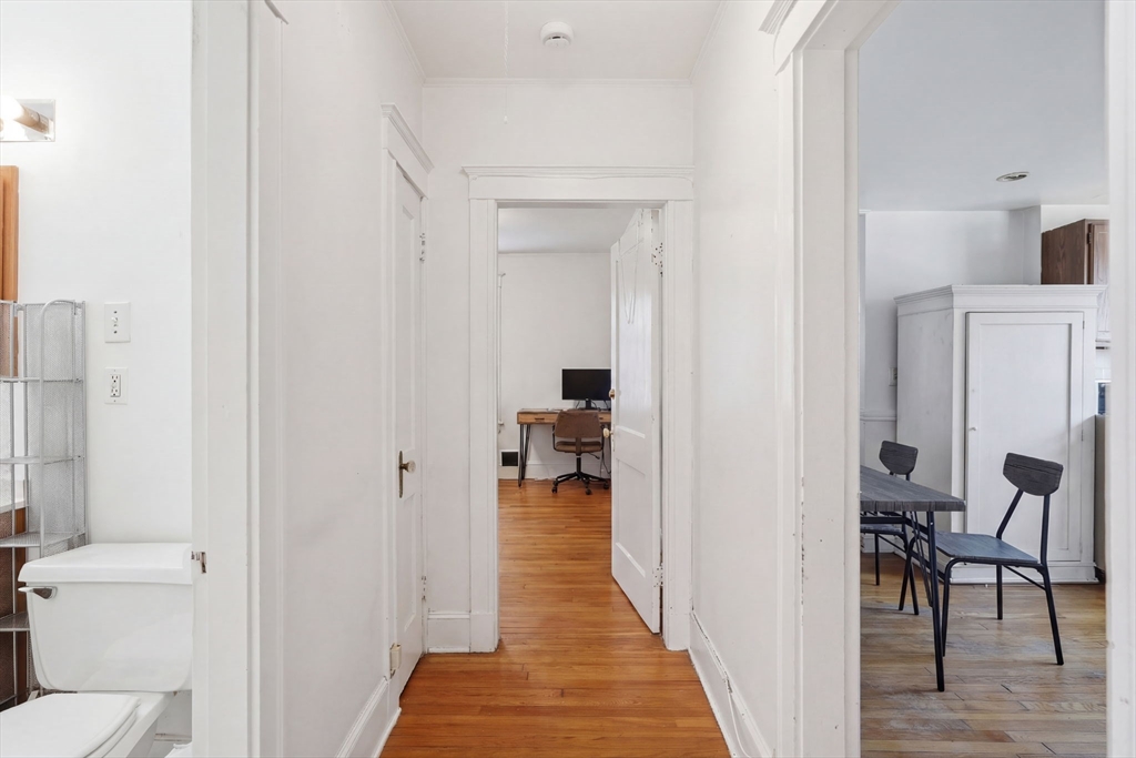 14 Stockwell Street, Unit 2 Boston, MA 02120 - Photo 24 of 29 a hallway with wooden floor a bathroom and a sink