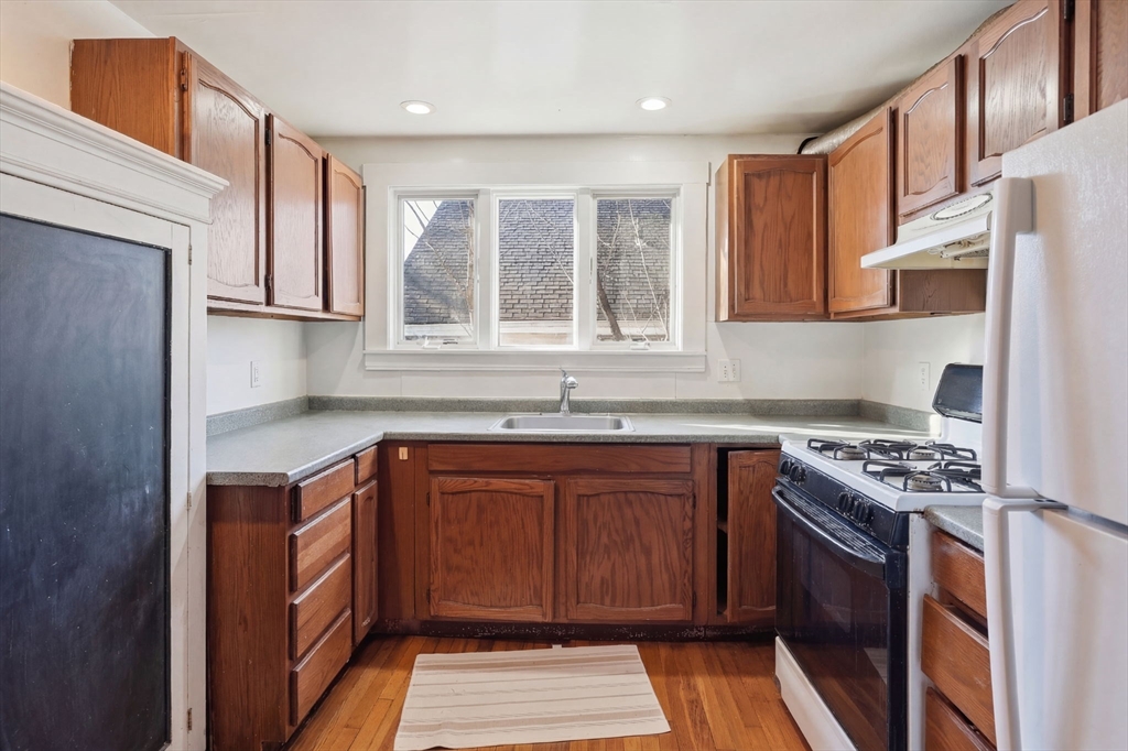 14 Stockwell Street, Unit 2 Boston, MA 02120 - Photo 25 of 29 a kitchen with stainless steel appliances granite countertop a stove a sink dishwasher and a refrigerator