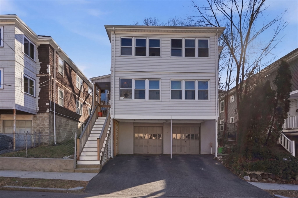 14 Stockwell Street, Unit 2 Boston, MA 02120 - Photo 9 of 29 a front view of a building with a yard