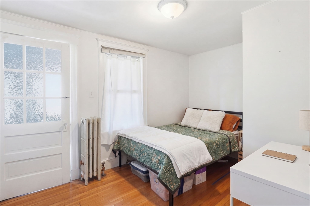 14 Stockwell Street, Unit 2 Boston, MA 02120 - Photo 10 of 29 a bedroom with a bed and a window