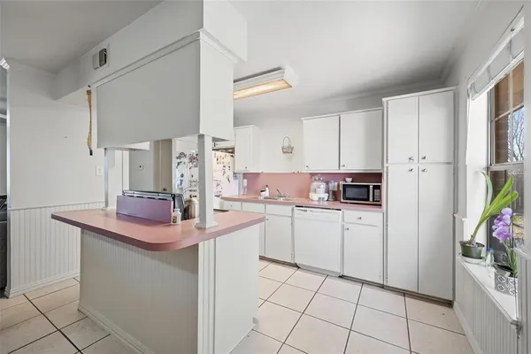 a kitchen with appliances cabinets and furniture